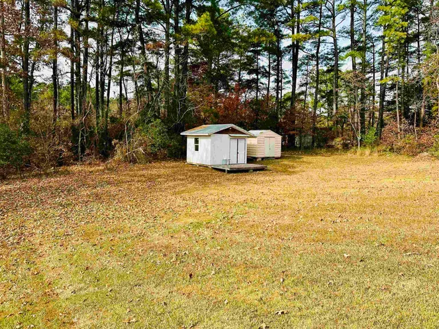a white house that has a tree in front of it