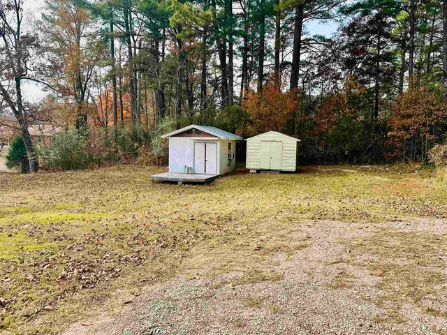a white house that has a tree in front of it