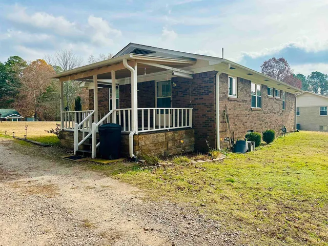 a view of a house with a yard and roof