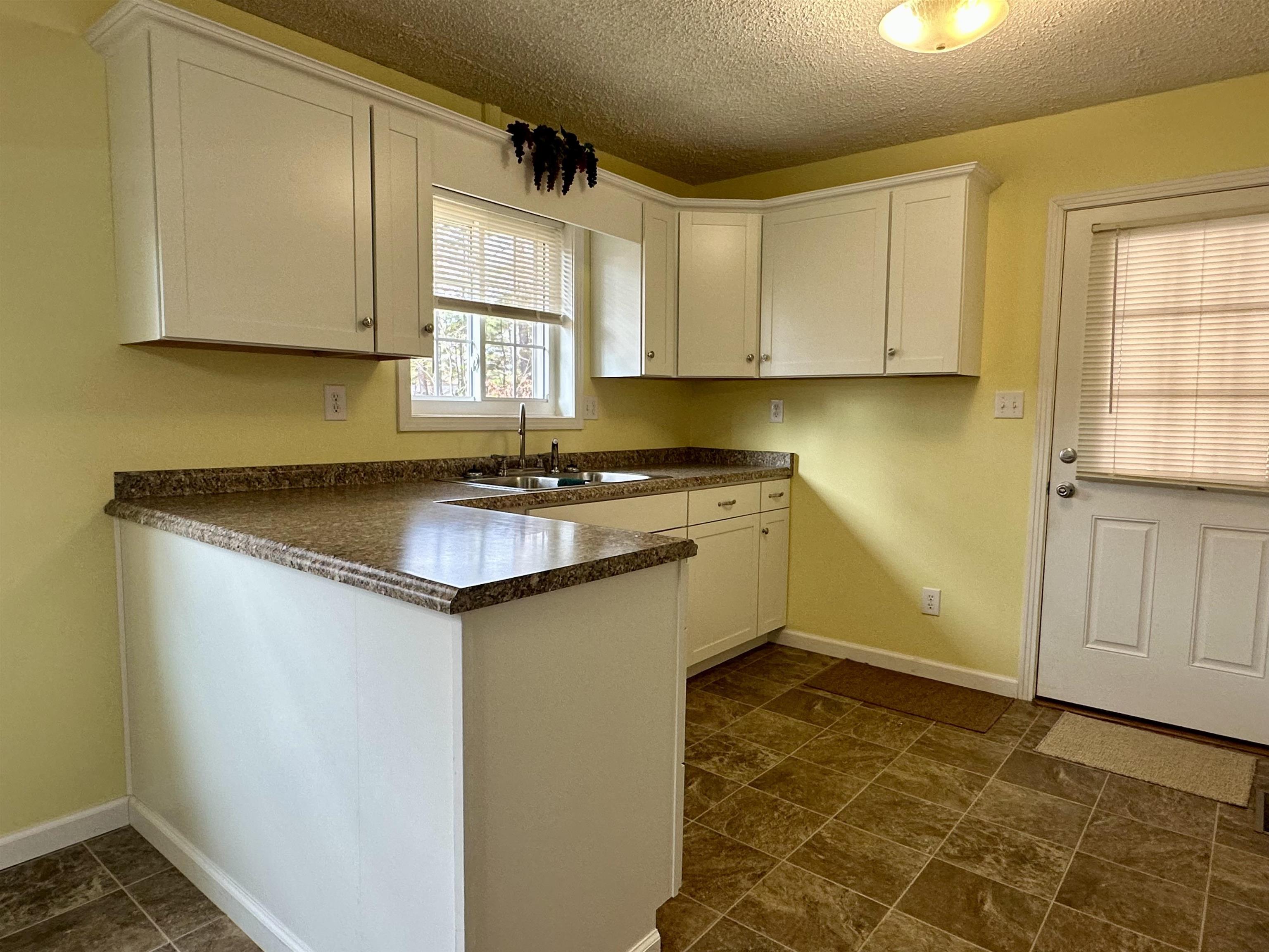 170 Mitchell Street Selmer, TN 38375 - Photo 4 of 26 a kitchen with stainless steel appliances granite countertop a sink stove and cabinets