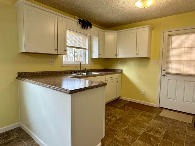 a kitchen with stainless steel appliances granite countertop a sink stove and cabinets
