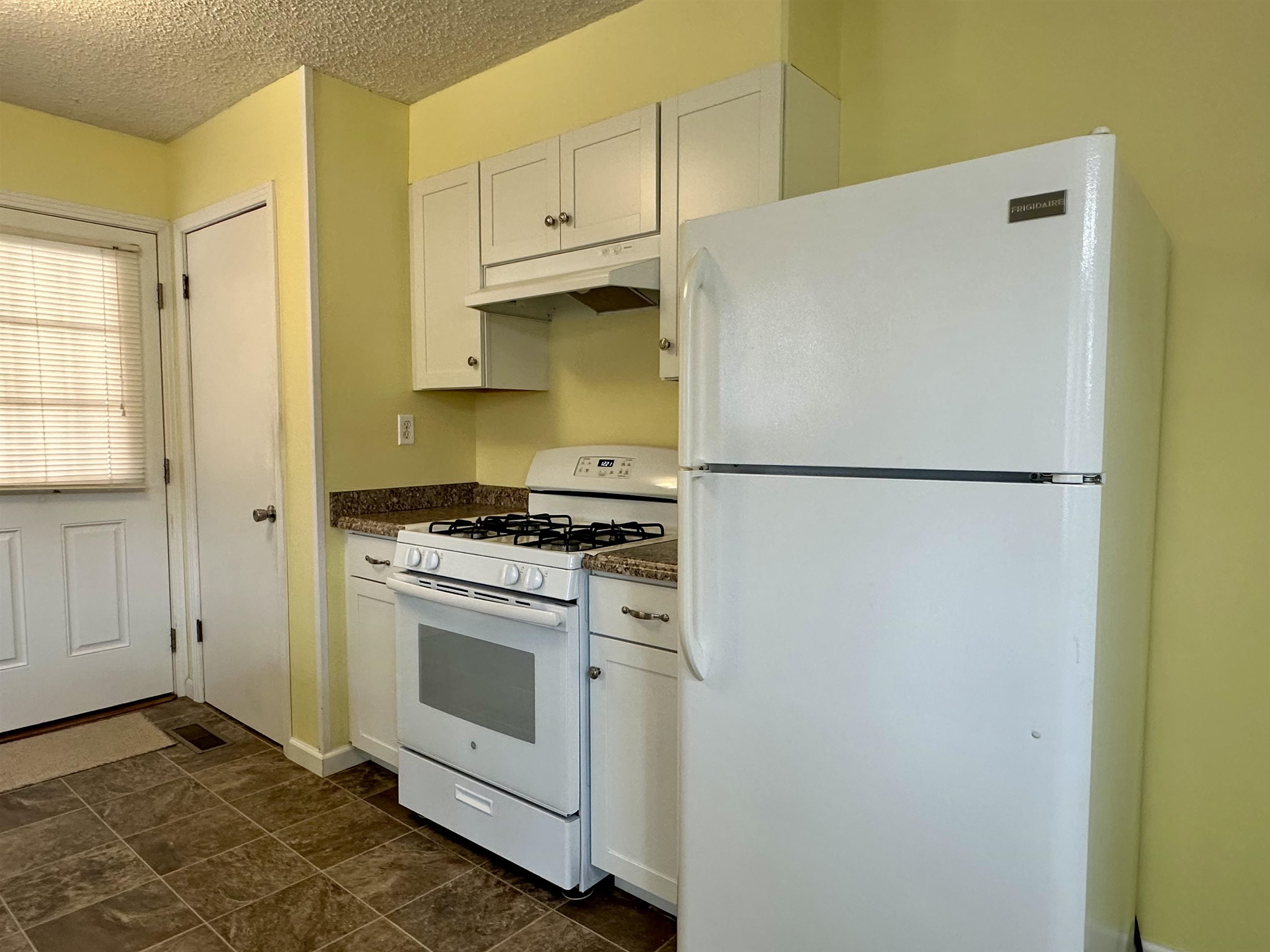 170 Mitchell Street Selmer, TN 38375 - Photo 6 of 26 a kitchen with a stove a refrigerator and a sink