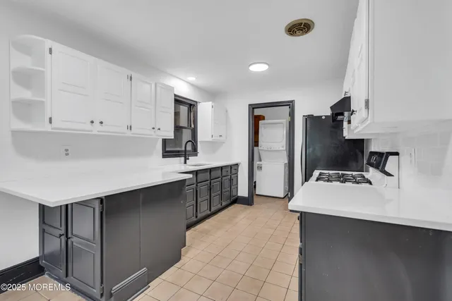 a kitchen with kitchen island sink stove and refrigerator