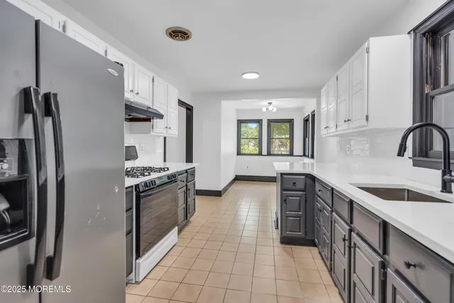 a kitchen with stainless steel appliances granite countertop a refrigerator and a sink