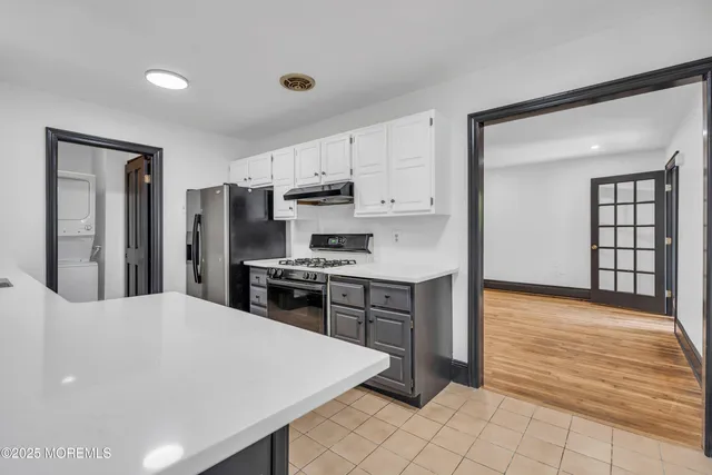 a kitchen with stainless steel appliances a refrigerator sink and stove