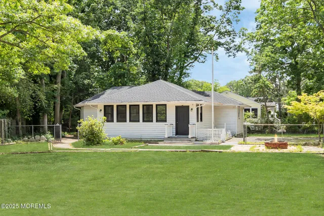 a front view of a house with a yard table and chairs