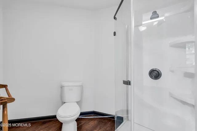 a bathroom with a toilet and a shower