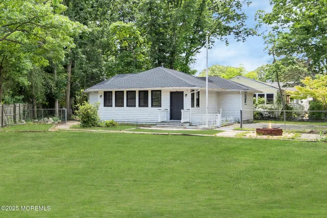 a front view of a house with a yard table and chairs