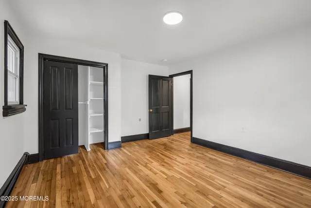 a view of a room with wooden floor and bathroom