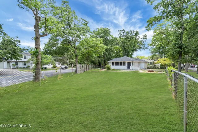 a house view with swimming pool in front of it