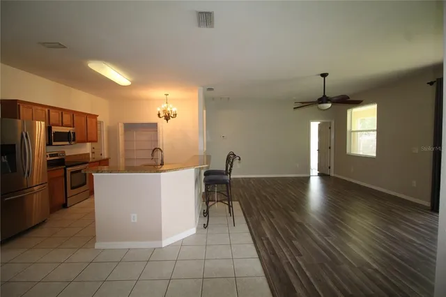 a kitchen with stainless steel appliances a refrigerator and a stove top oven