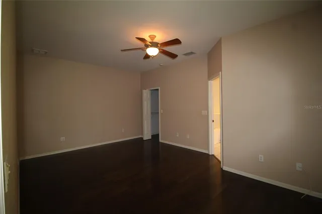 a view of a room with wooden floor and windows