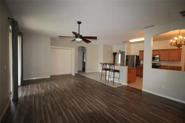 a view of a room with furniture and wooden floor