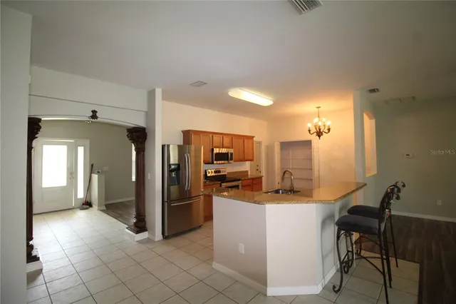 a kitchen with stainless steel appliances kitchen island granite countertop a sink and cabinets