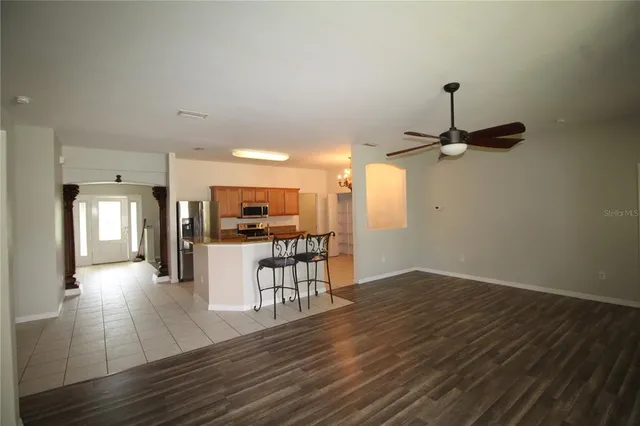 a view of a kitchen with cabinets and wooden floor