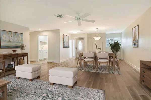 an empty room with a window and a fan