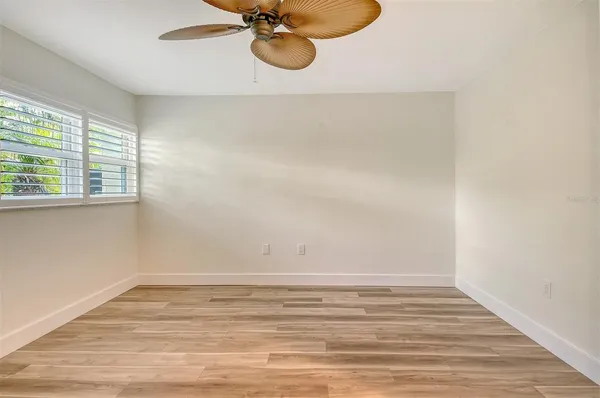 a view of a room with wooden floor