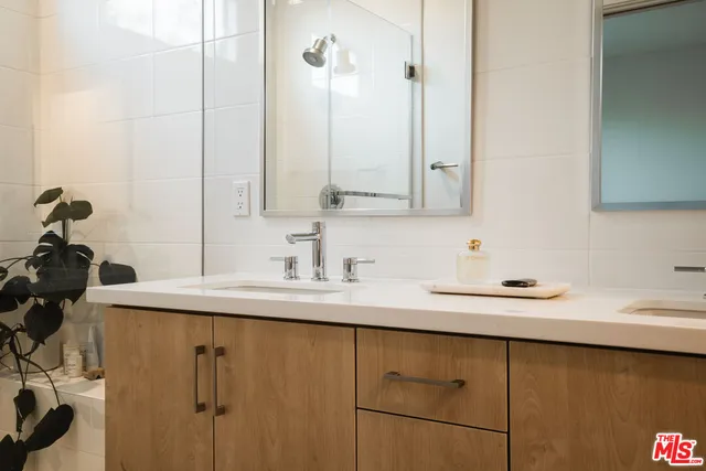 a white toilet sitting next to a bathroom sink