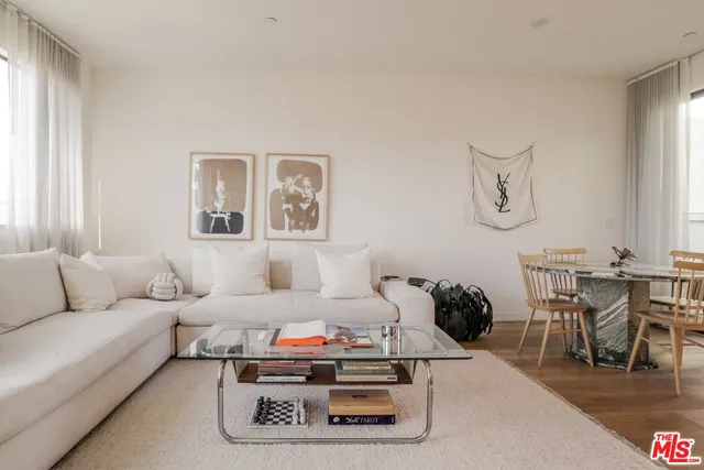 a living room with furniture and a dining table