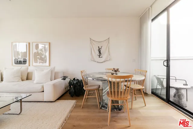 a view of a dining room with furniture and a window