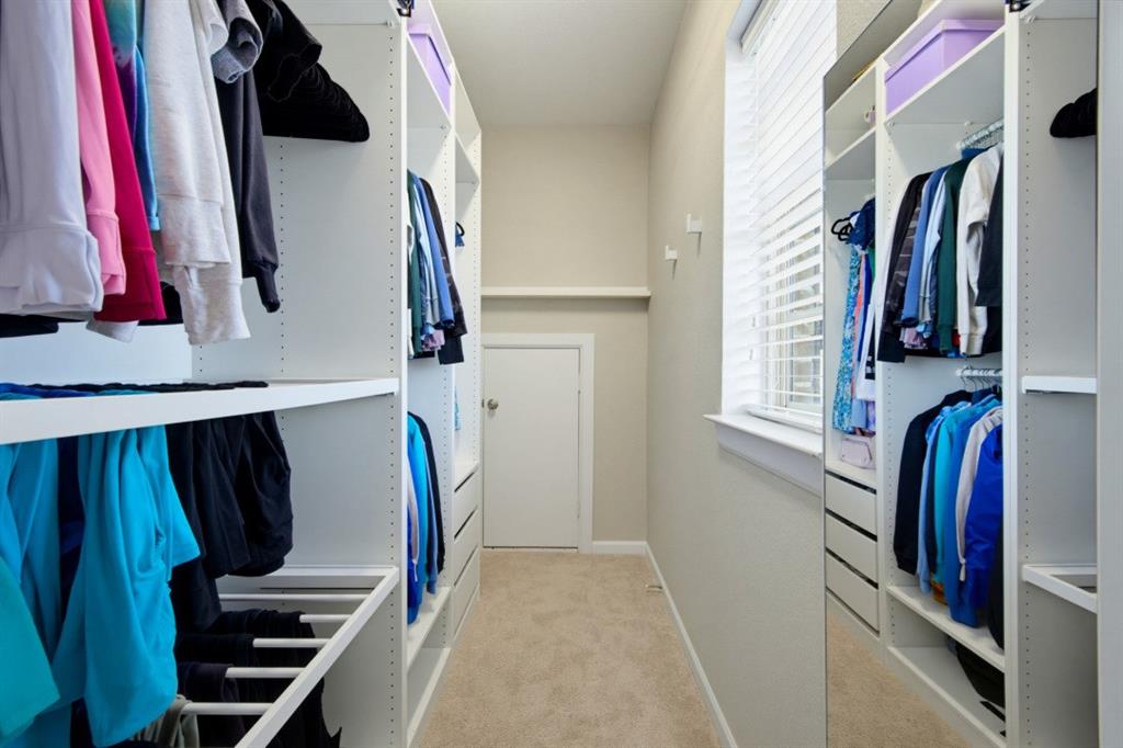 2721 Old Shire Path Road Prosper, TX 75078 - Photo 26 of 39 Custom closet system featuring extensive shelving, hanging rods, integrated drawers, and a full-length mirrored panel