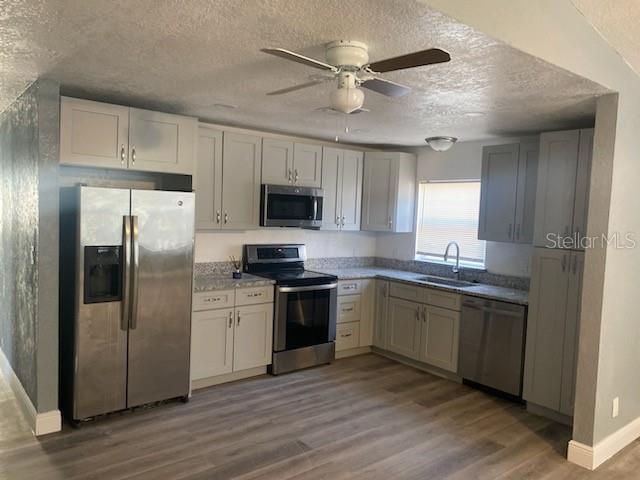 724 Grove Avenue Orlando, FL 32805 - Photo 2 of 6 a kitchen with stainless steel appliances granite countertop a refrigerator a stove a sink and a microwave