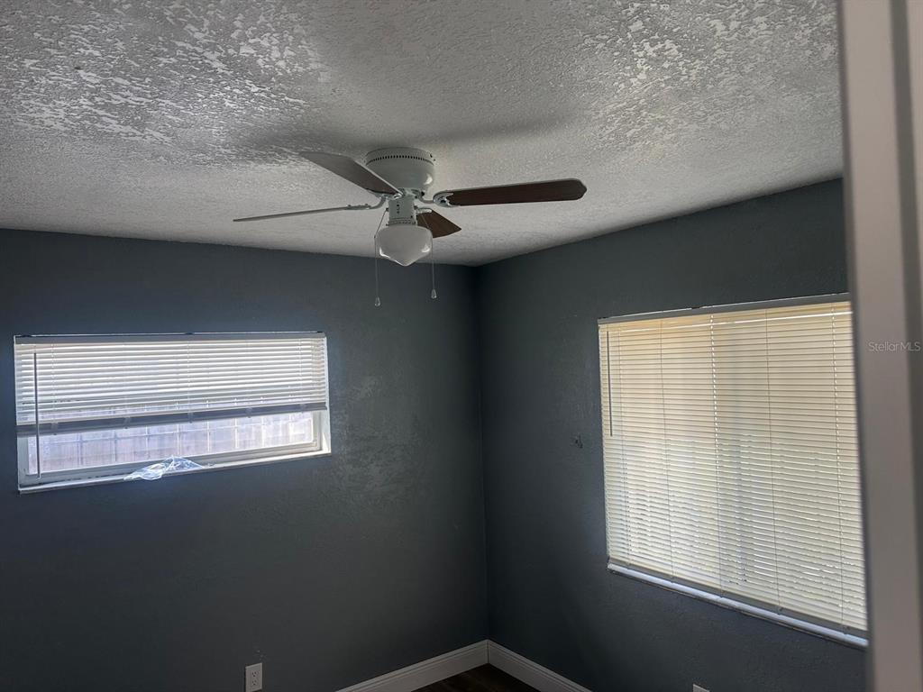 724 Grove Avenue Orlando, FL 32805 - Photo 3 of 6 a view of a livingroom with an empty space a ceiling fan and window