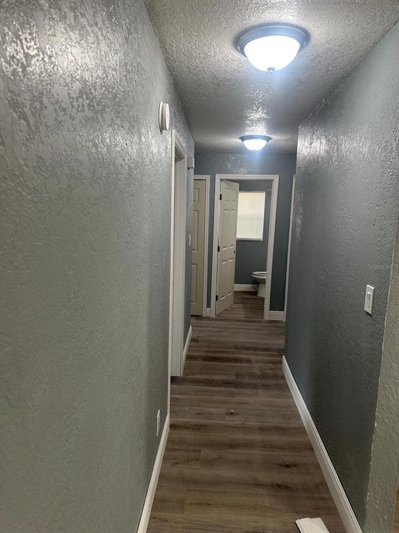 724 Grove Avenue Orlando, FL 32805 - Photo 6 of 6 a view of a hallway with wooden floor and staircase