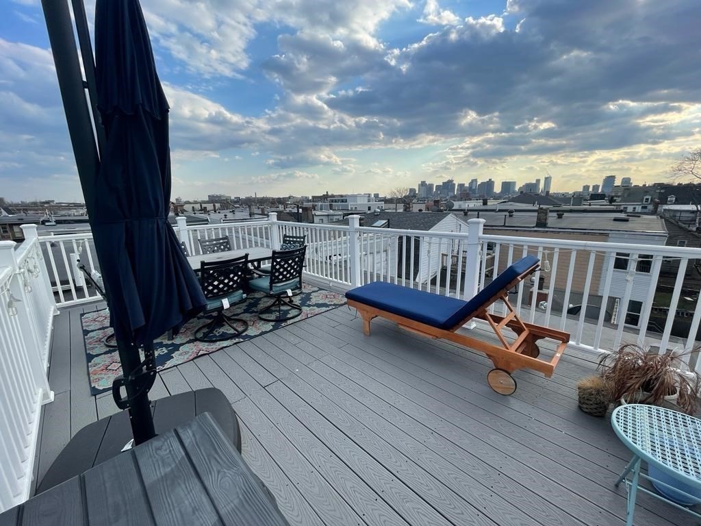 an outdoor view from a balcony with lounge chair