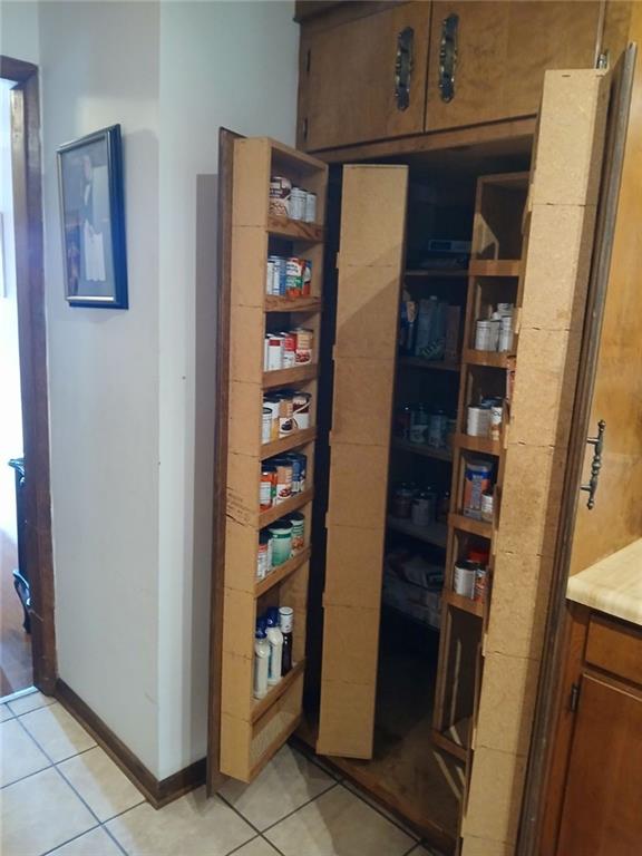 707 Campbell Town Road Walhalla, SC 29691 - Photo 12 of 19 A clever, built-in pantry maximizes storage with pull-out shelving, seamlessly integrating into the kitchen's warm wooden cabinetry.