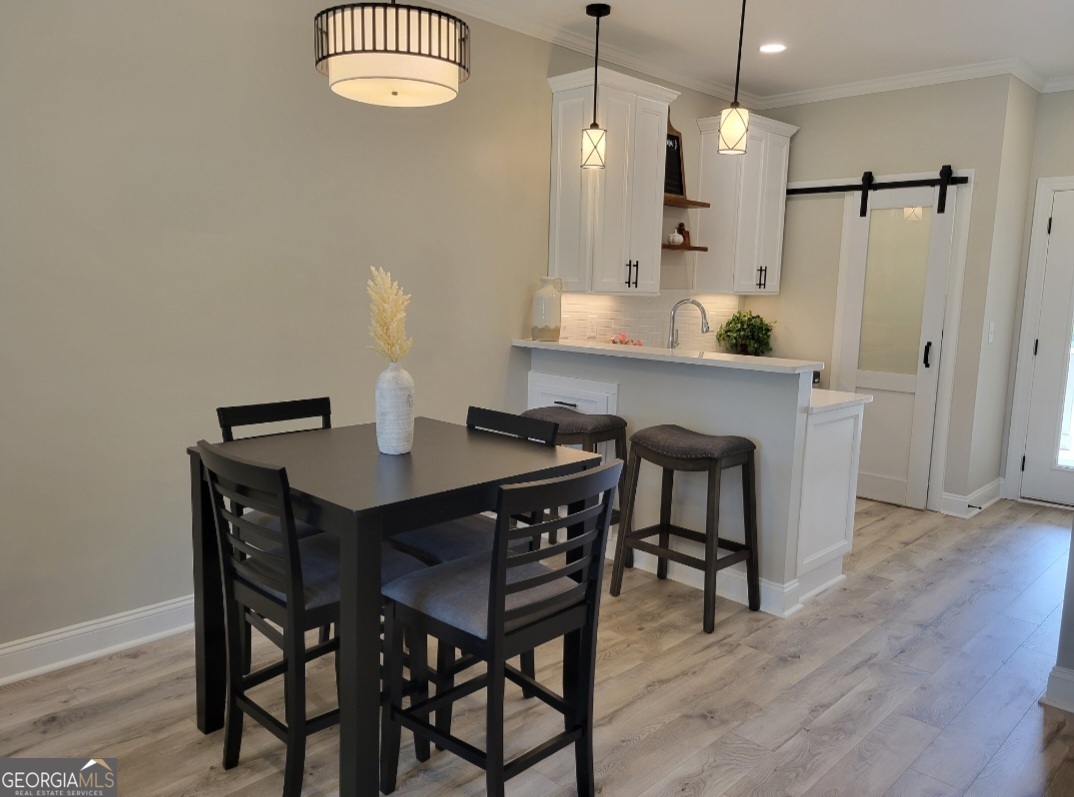 323 South Madison Avenue Monroe, GA 30655 - Photo 12 of 39 a kitchen with a table and chairs in it