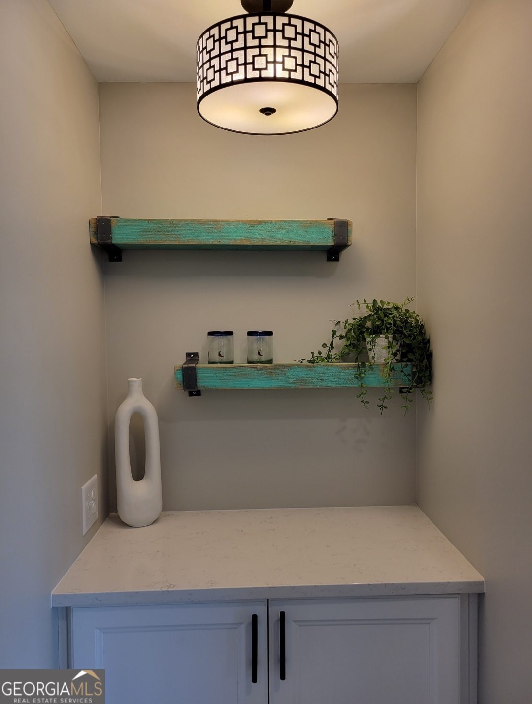 323 South Madison Avenue Monroe, GA 30655 - Photo 14 of 39 a table with a vase and white countertops with wooden floor