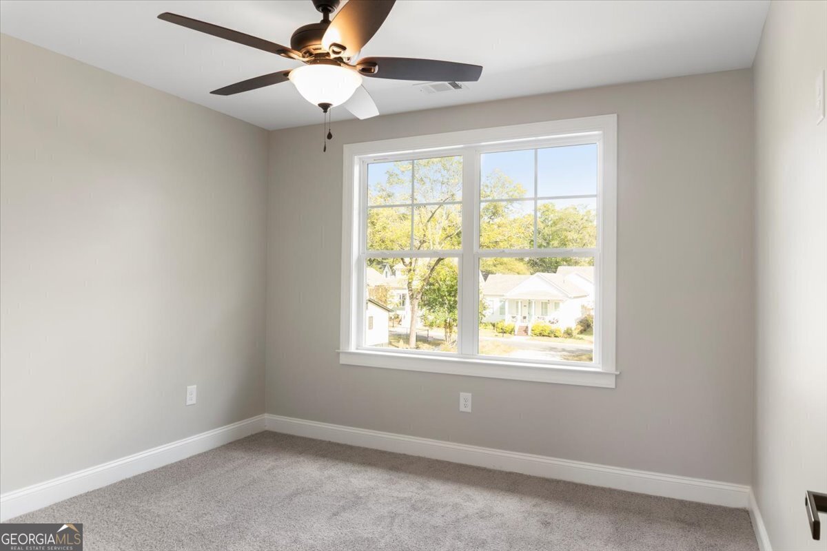 323 South Madison Avenue Monroe, GA 30655 - Photo 25 of 39 an empty room with a window and a fan
