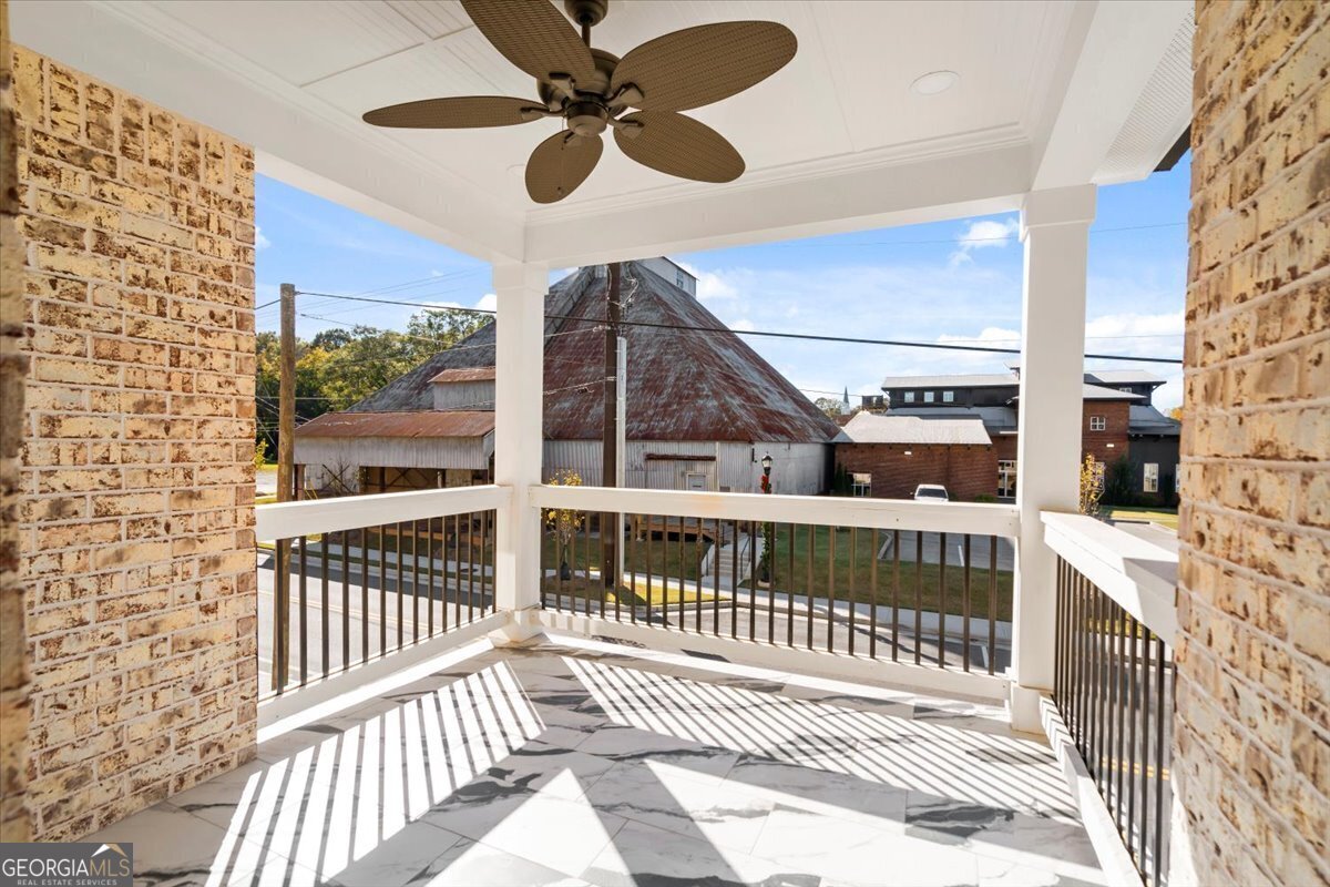 323 South Madison Avenue Monroe, GA 30655 - Photo 33 of 39 a view of a balcony with a ceiling fan