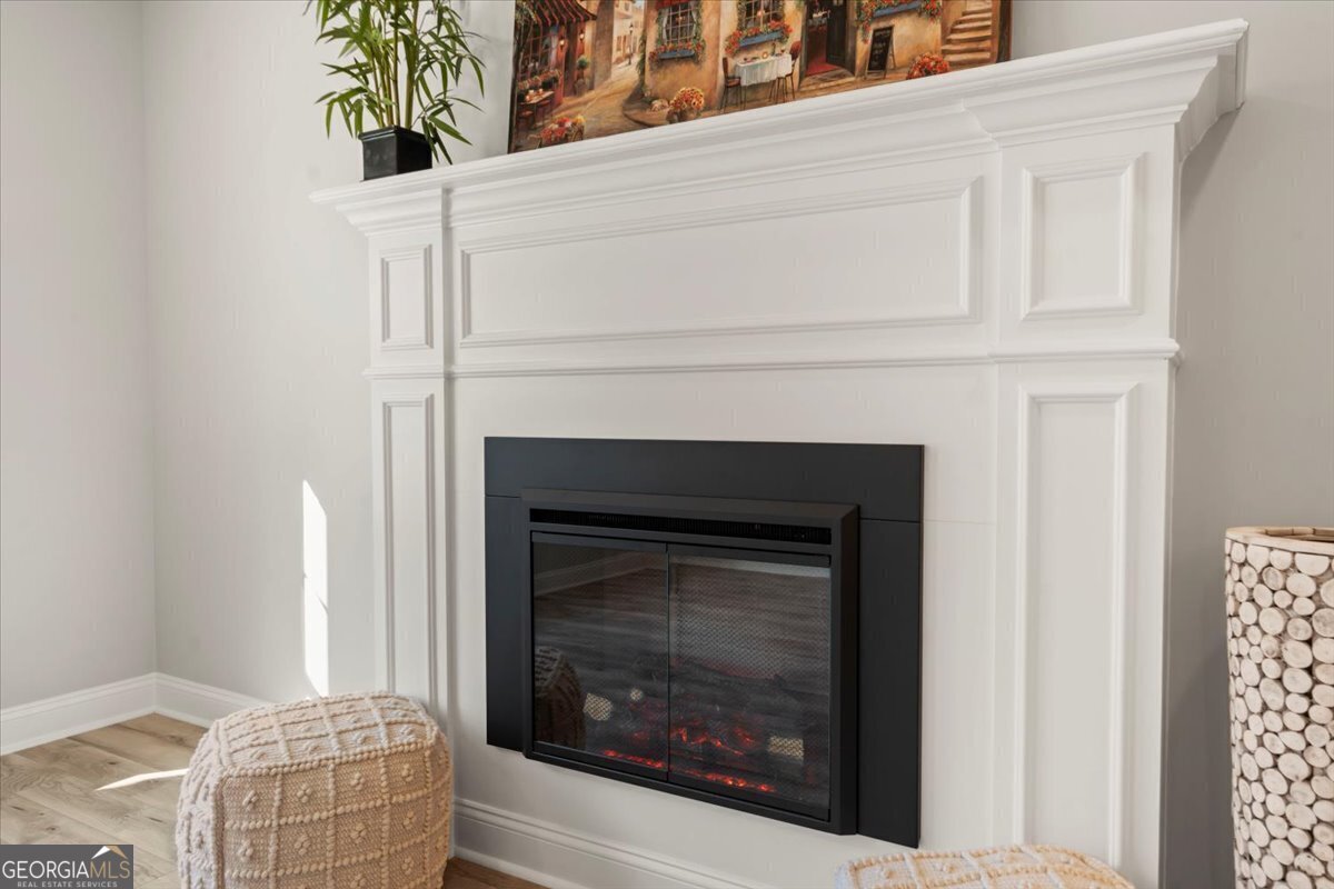 323 South Madison Avenue Monroe, GA 30655 - Photo 7 of 39 a living room with a fireplace and a potted plant