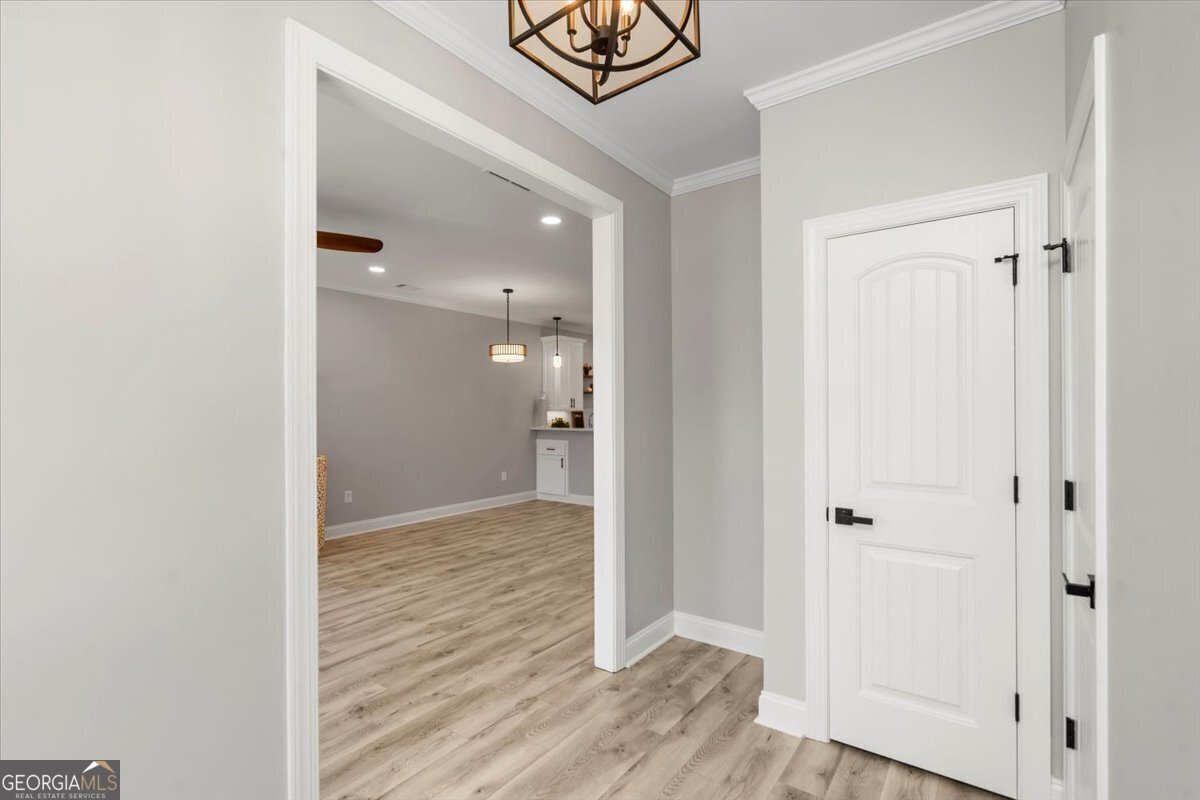 323 South Madison Avenue Monroe, GA 30655 - Photo 10 of 39 a view of a hallway with wooden floor and closet