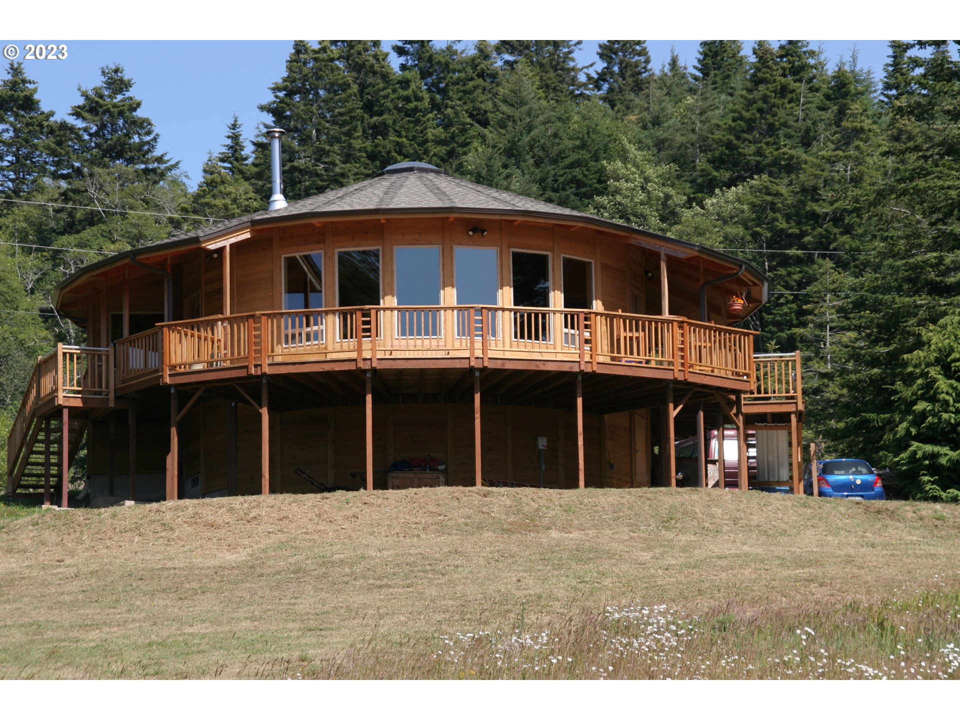 35606 Coy Creek Road Gold Beach, OR 97444 - Photo 1 of 48 a front view of a house with a garden