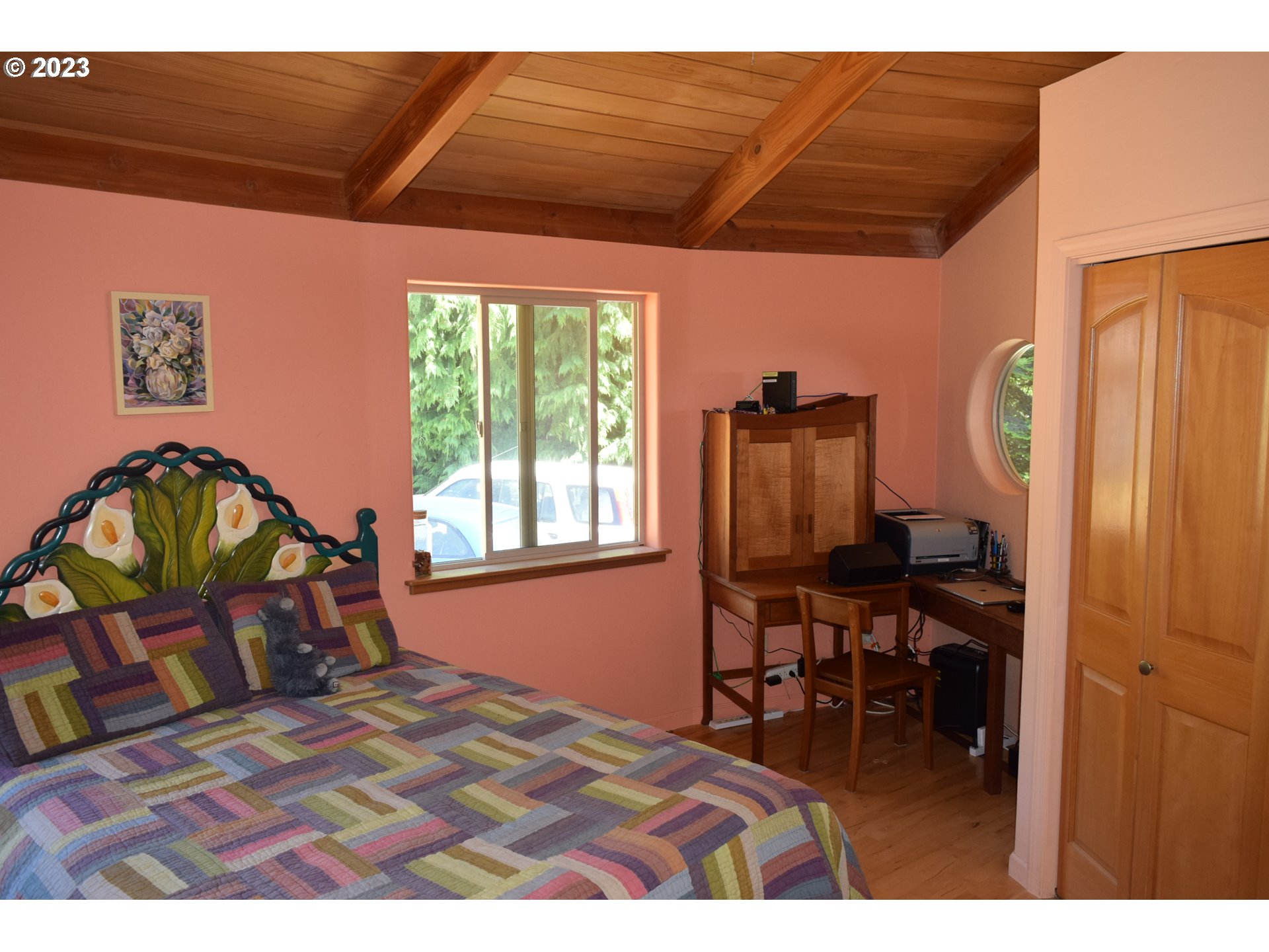 35606 Coy Creek Road Gold Beach, OR 97444 - Photo 25 of 48 a bedroom with furniture and a window