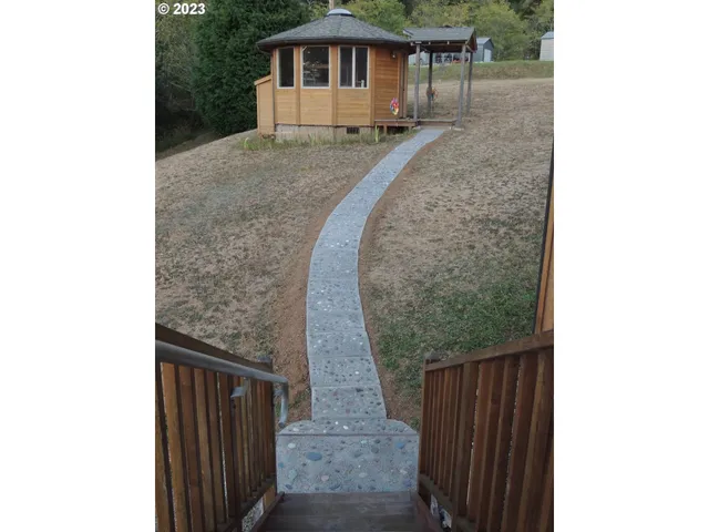 a backyard of a house with yard and outdoor seating