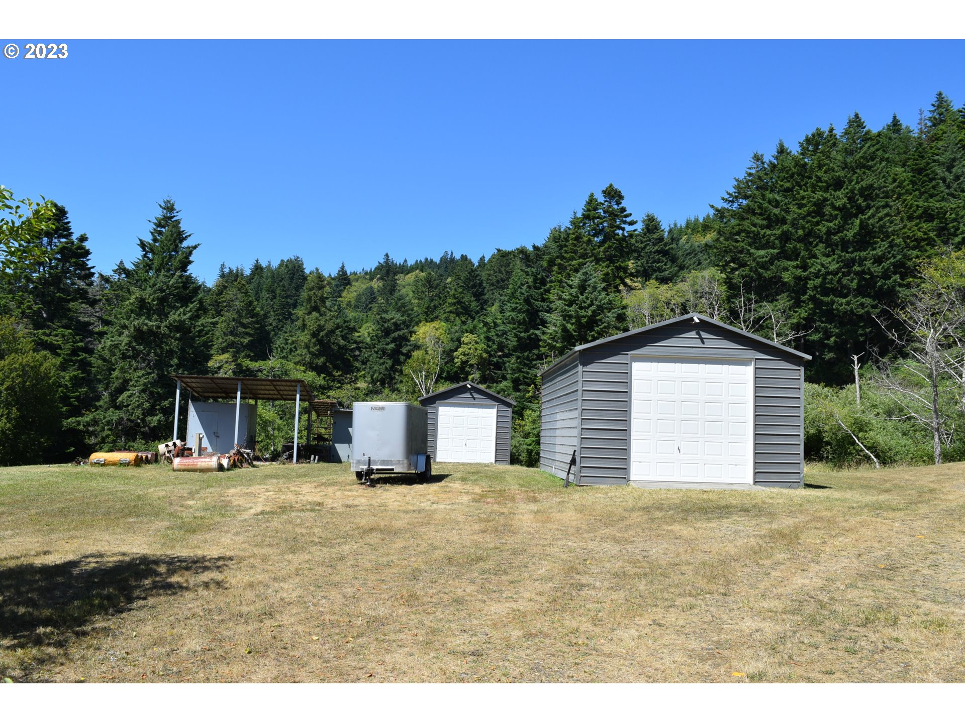 35606 Coy Creek Road Gold Beach, OR 97444 - Photo 37 of 48 a house with trees in the background