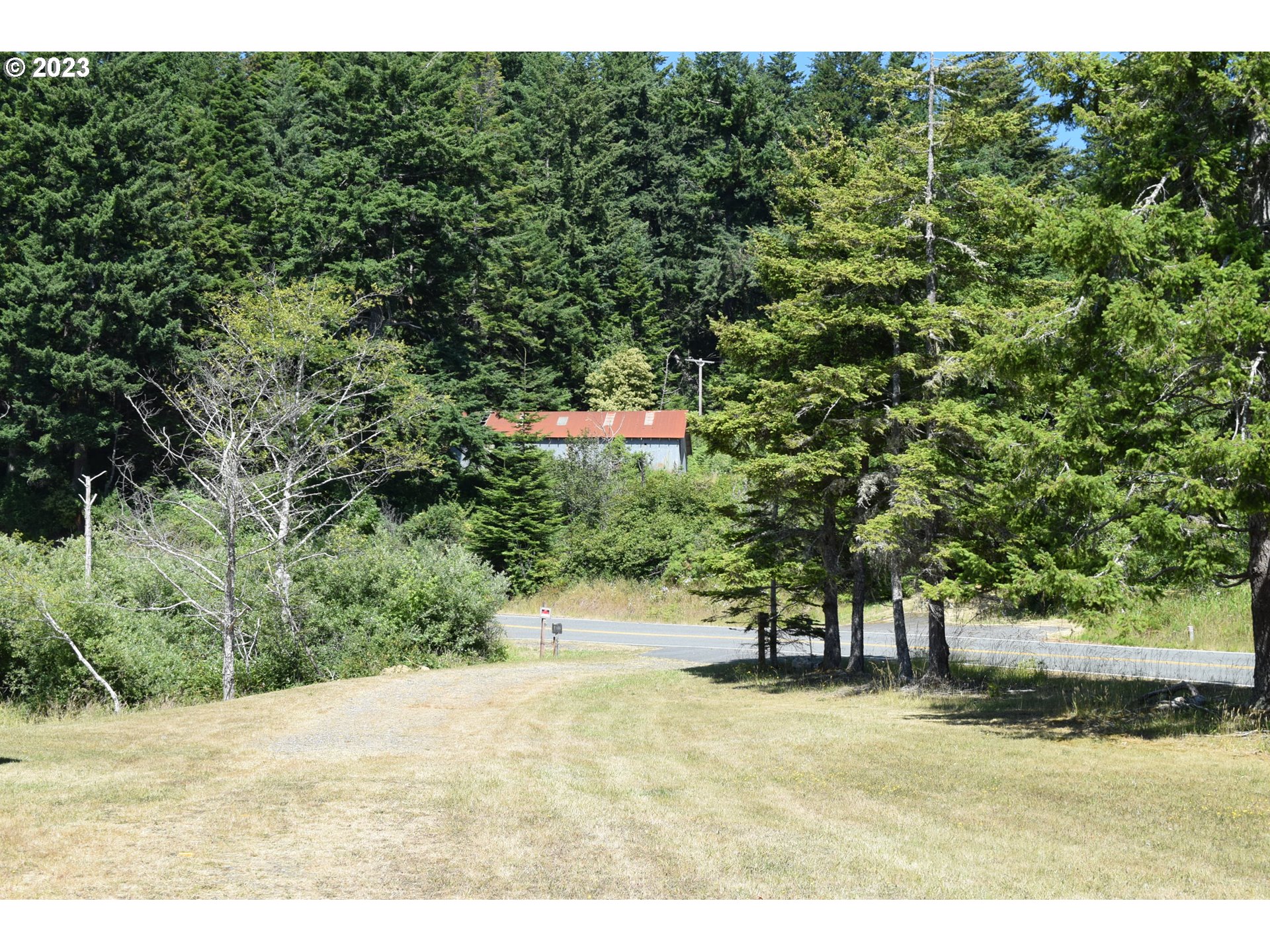 35606 Coy Creek Road Gold Beach, OR 97444 - Photo 40 of 48 a view of a street with trees in the background