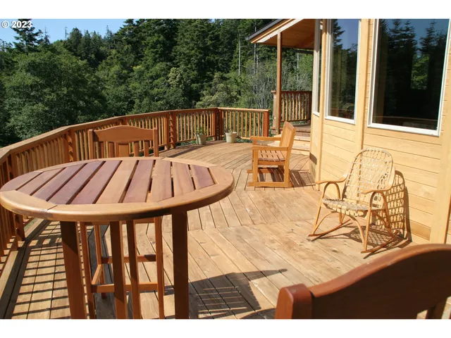 a view of balcony with wooden floor and outdoor seating