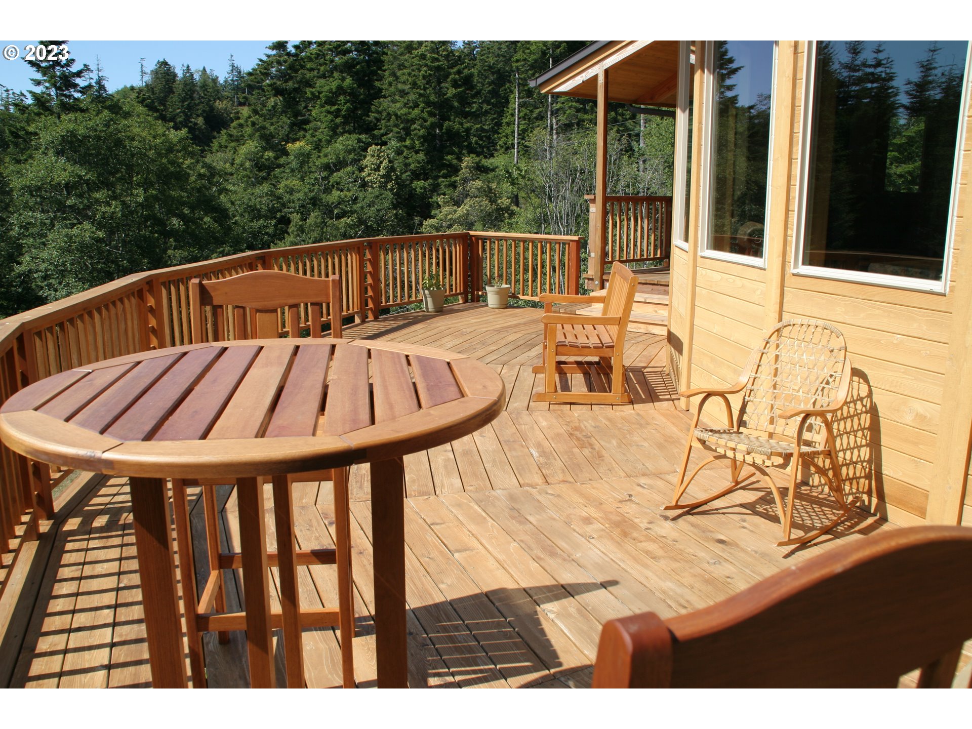 35606 Coy Creek Road Gold Beach, OR 97444 - Photo 6 of 48 a view of balcony with wooden floor and outdoor seating