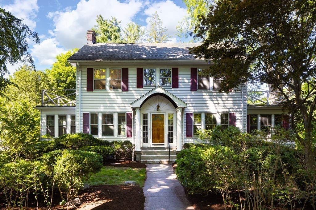 a front view of a house with a garden