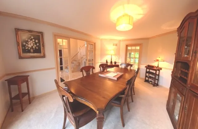 a dining room with a table and chairs