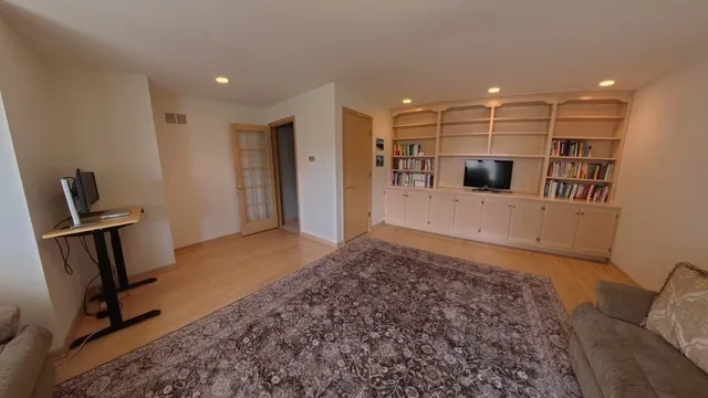 a view of a livingroom with furniture and a flat screen tv