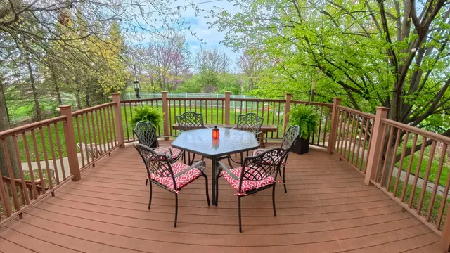 a view of a deck with furniture and wooden floor