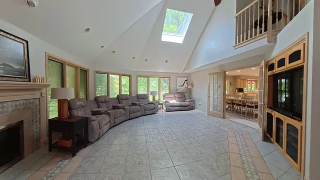 a living room with furniture a fireplace and a large window