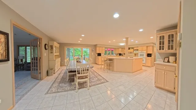 a living room with furniture a kitchen view and a refrigerator