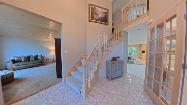 a view of entryway with furniture and stairs
